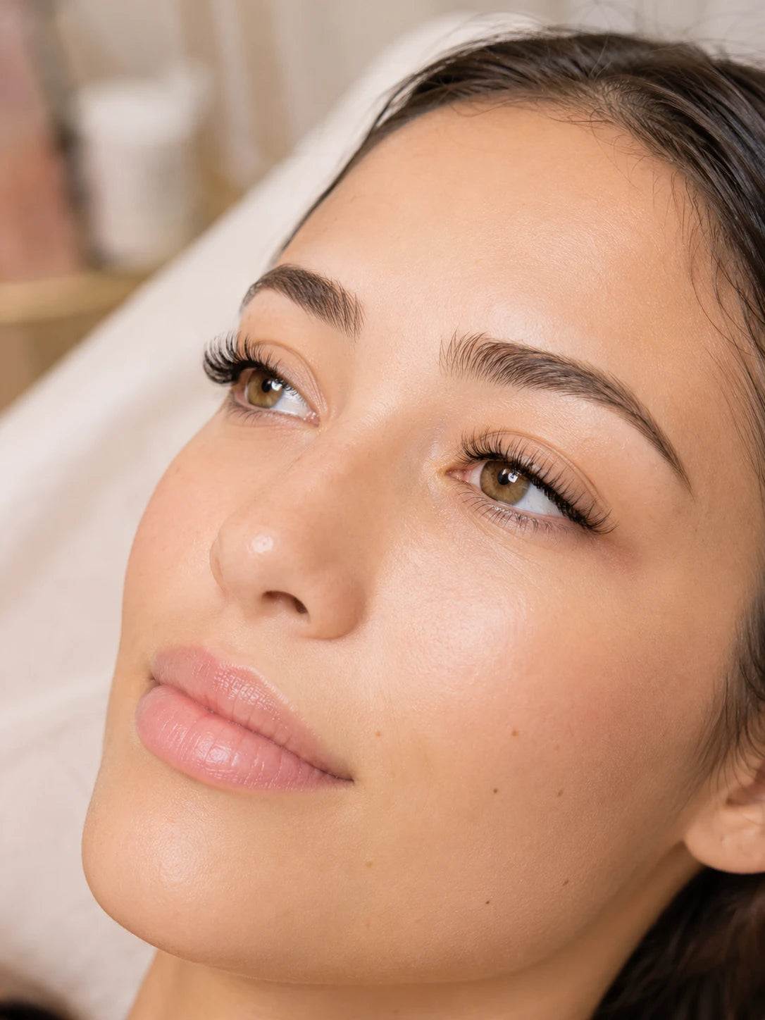 Close-up of natural volume eyelash extensions and groomed eyebrows on a female client near Chiswick