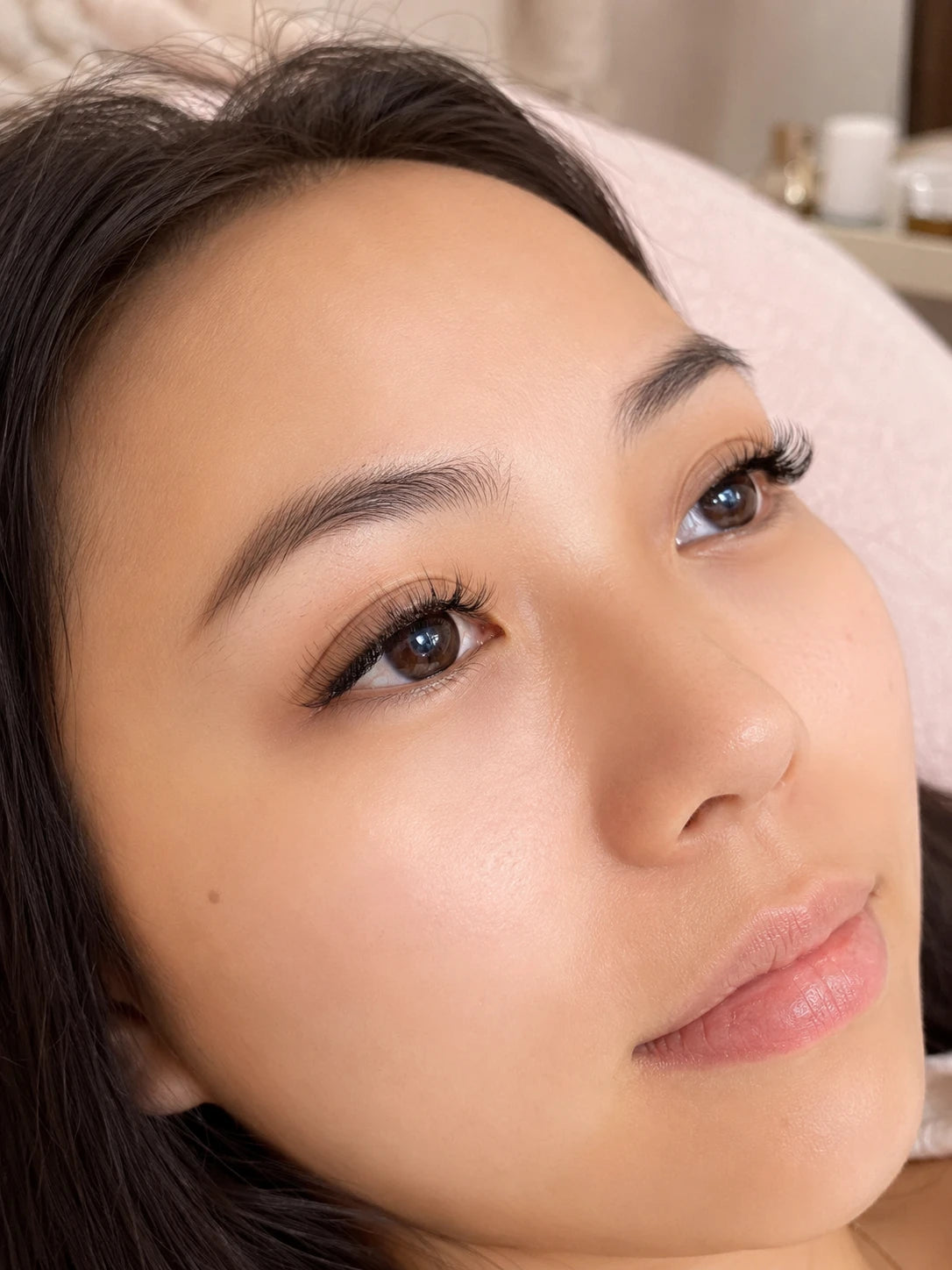 Close-up of natural volume eyelash extensions and groomed eyebrows on a female client near Ashfield
