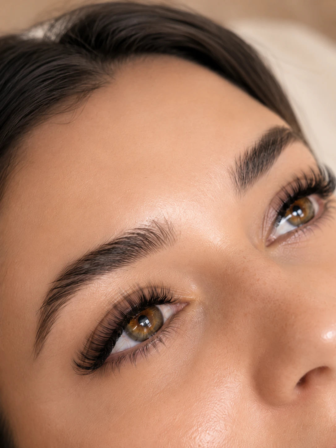 Close-up of full curled eyelash extensions and groomed eyebrows on a female client near Croydon