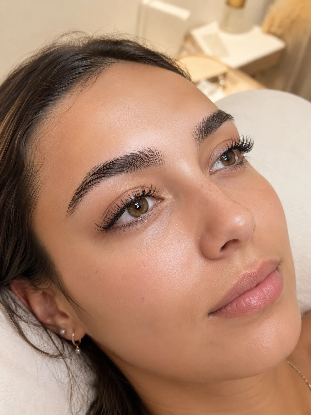 Close-up of natural volume eyelash extensions and groomed eyebrows on a female client near Lane Cove
