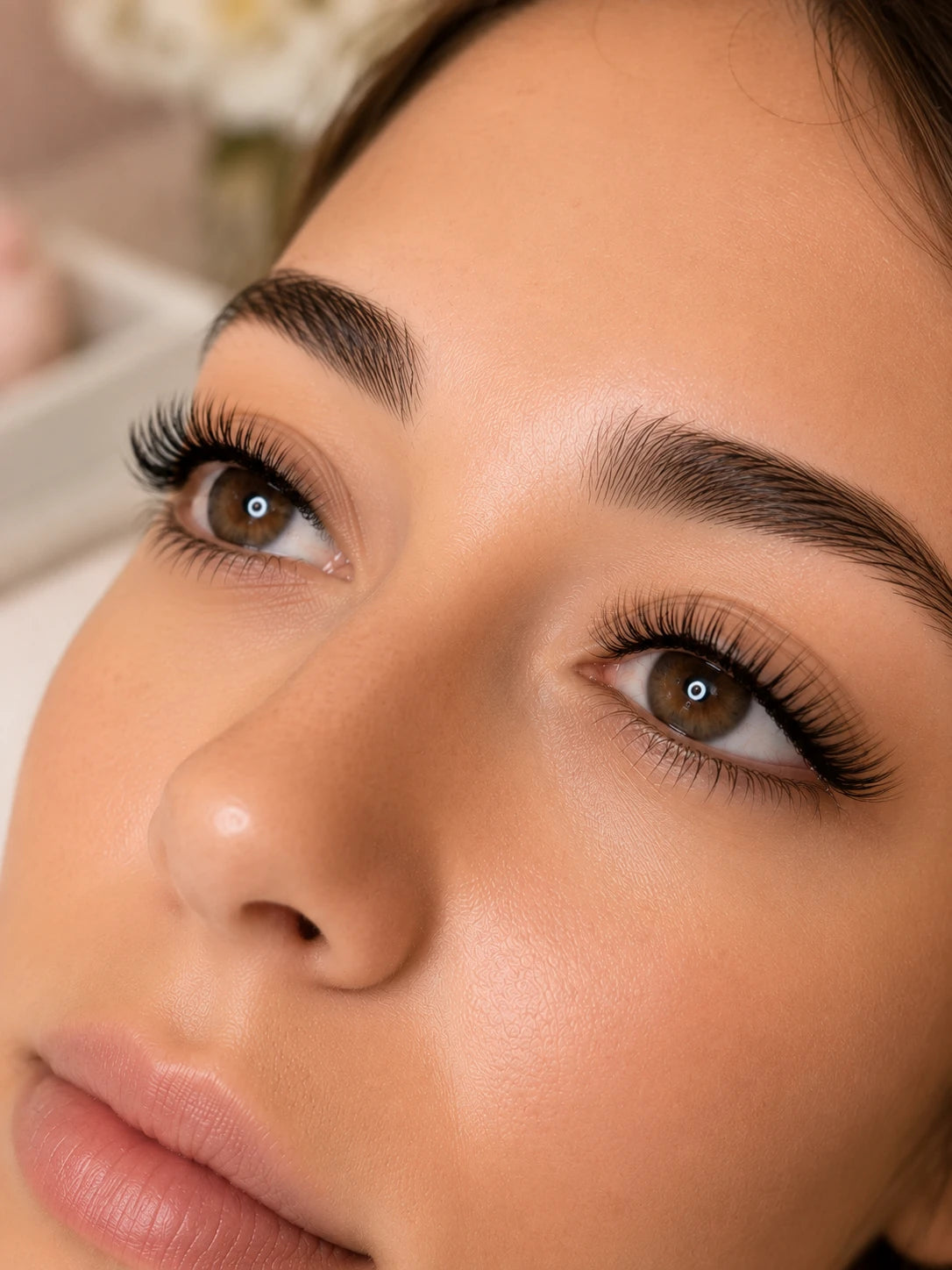 Close-up of natural volume eyelash extensions and groomed eyebrows on a female client near Leichhardt