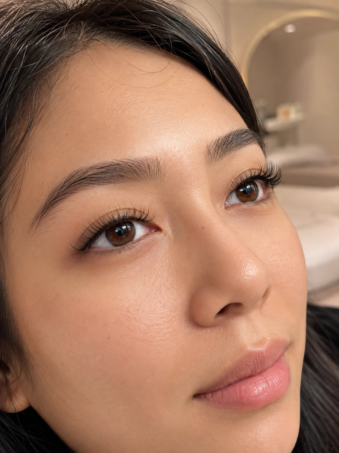 Close-up of natural volume eyelash extensions and groomed eyebrows on a female client near Macquarie Park