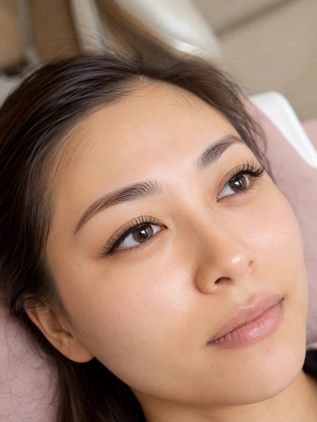 Close-up of natural volume eyelash extensions and groomed eyebrows on a female client near Rozelle