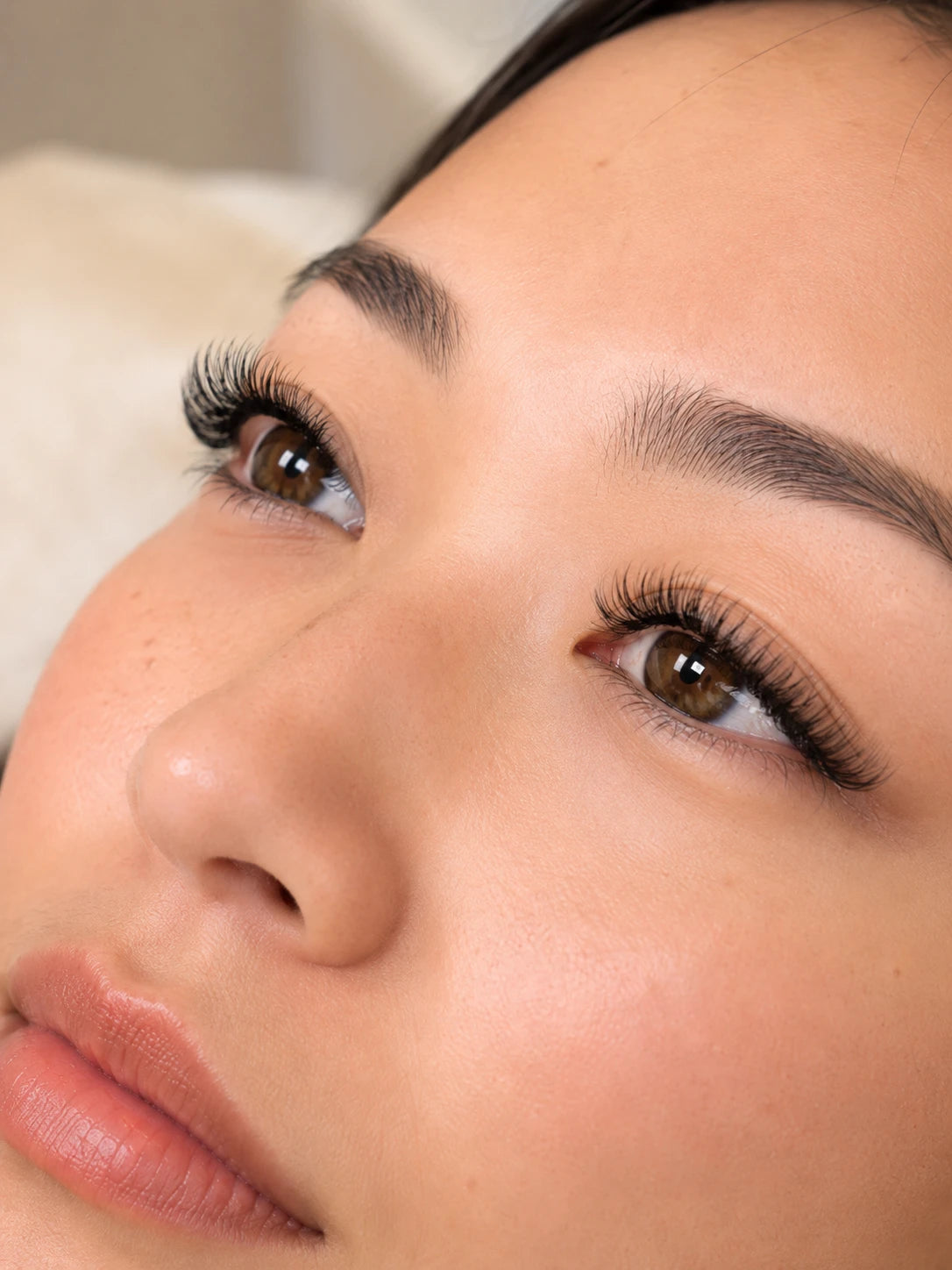 Close-up of soft volume eyelash extensions and groomed eyebrows on a female client near Rozelle