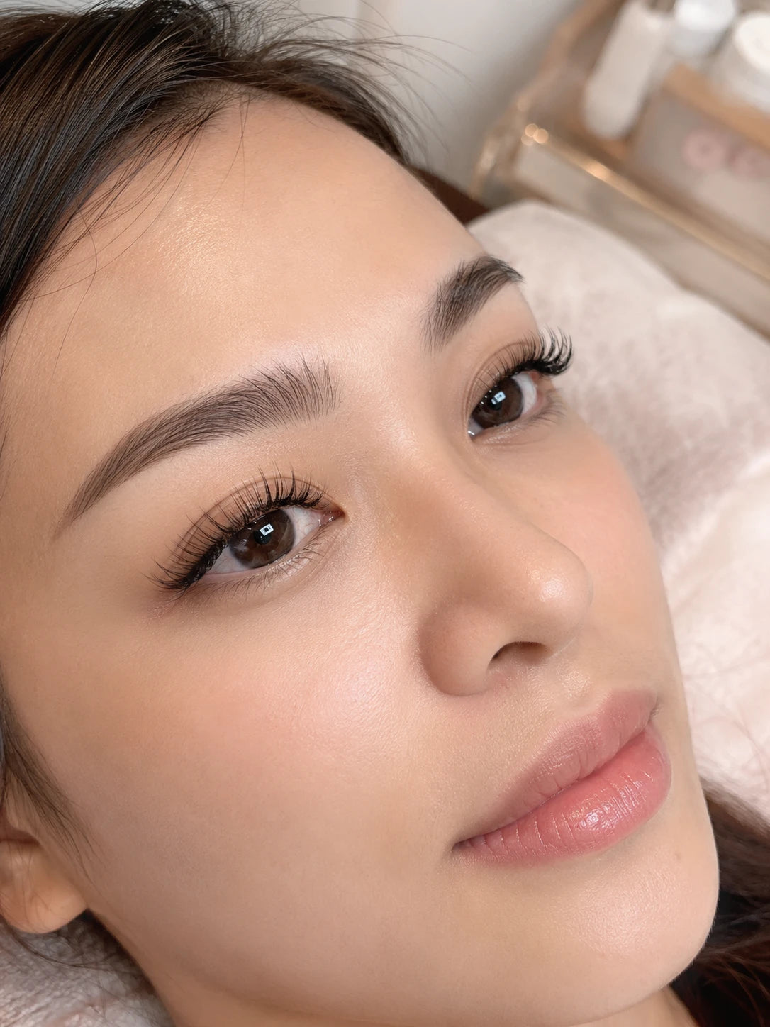 Close-up of natural eyelash extensions and groomed eyebrows on a female client near Strathfield