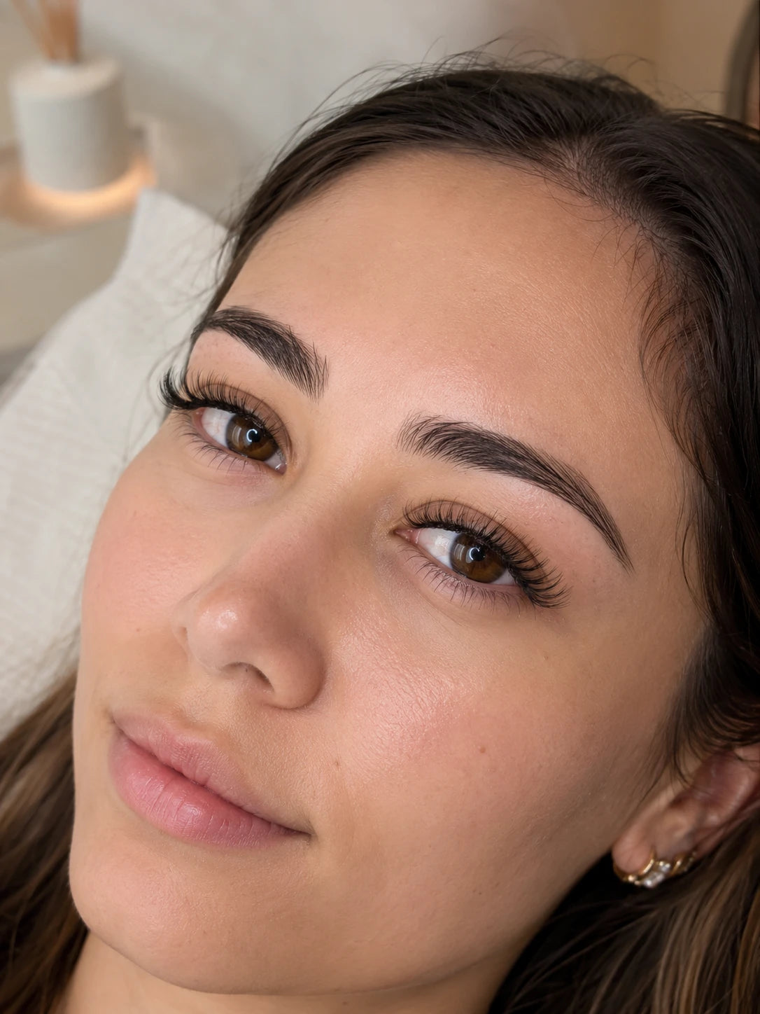 Close-up of natural volume eyelash extensions and groomed eyebrows on a female client near Abbotsford