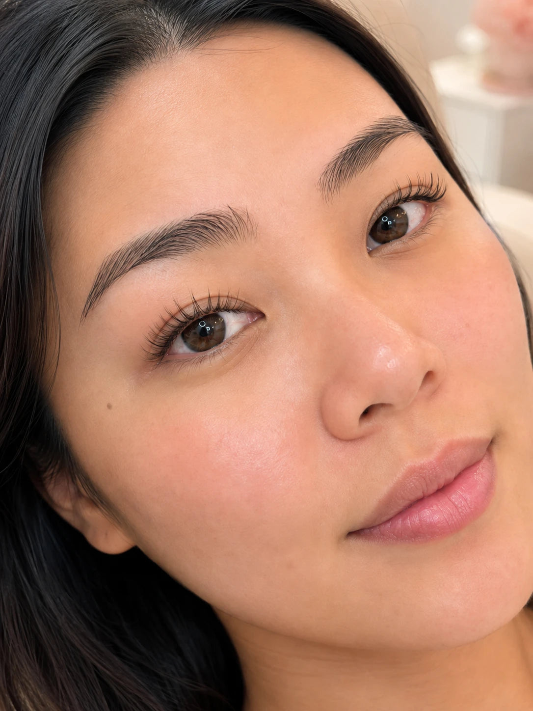Close-up of naturally lifted lashes and groomed eyebrows on a female client near Abbotsford