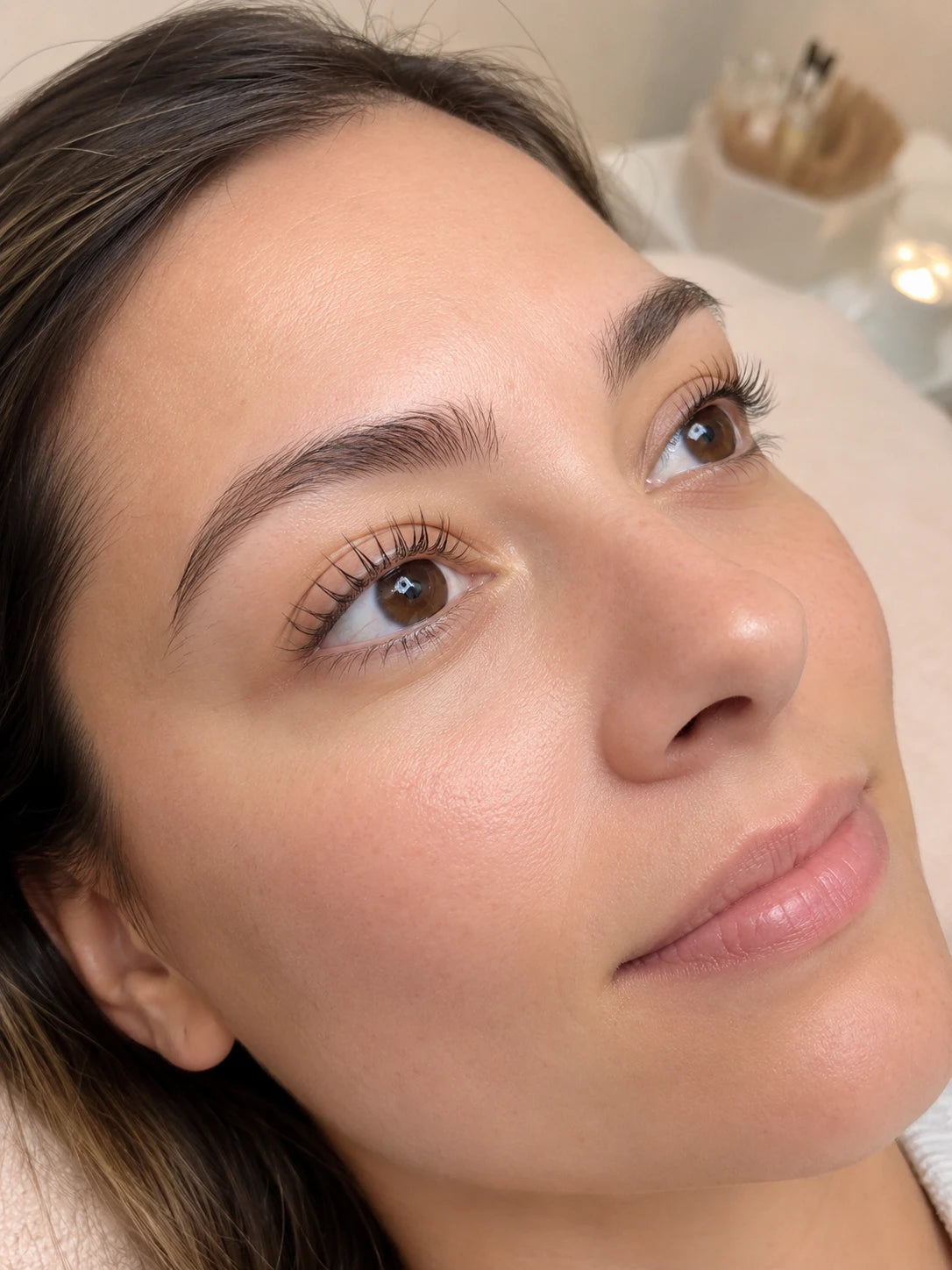 Close-up of natural lifted lashes and groomed eyebrows on a female client near Croydon