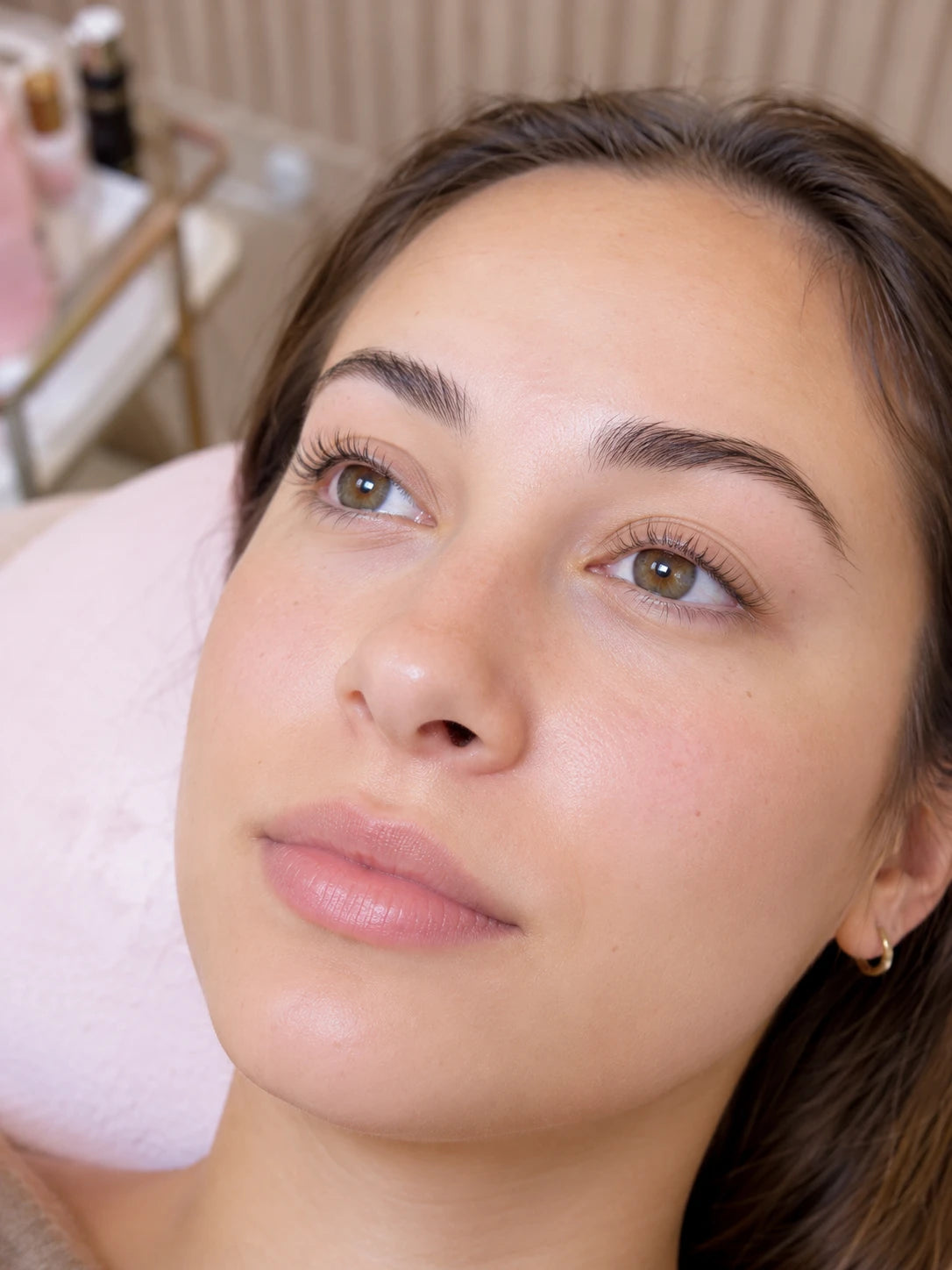 Close-up of natural lifted lashes and groomed eyebrows on a female client near Eastwood