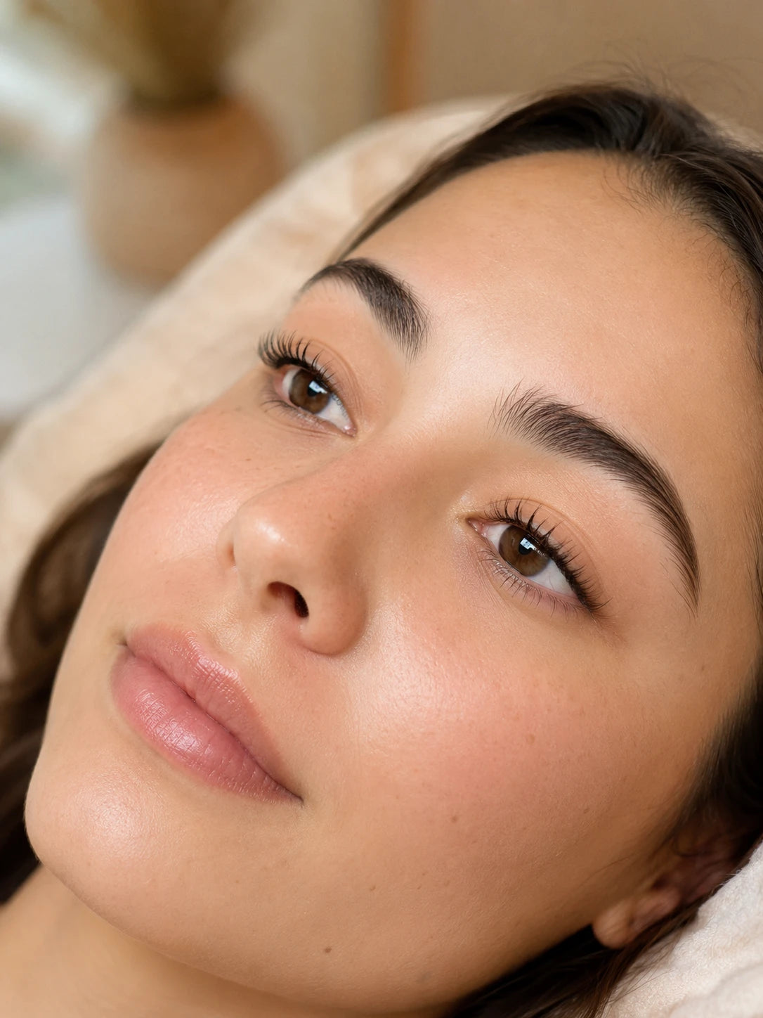 Close-up of natural lifted lashes and groomed eyebrows on a female client near Eastwood