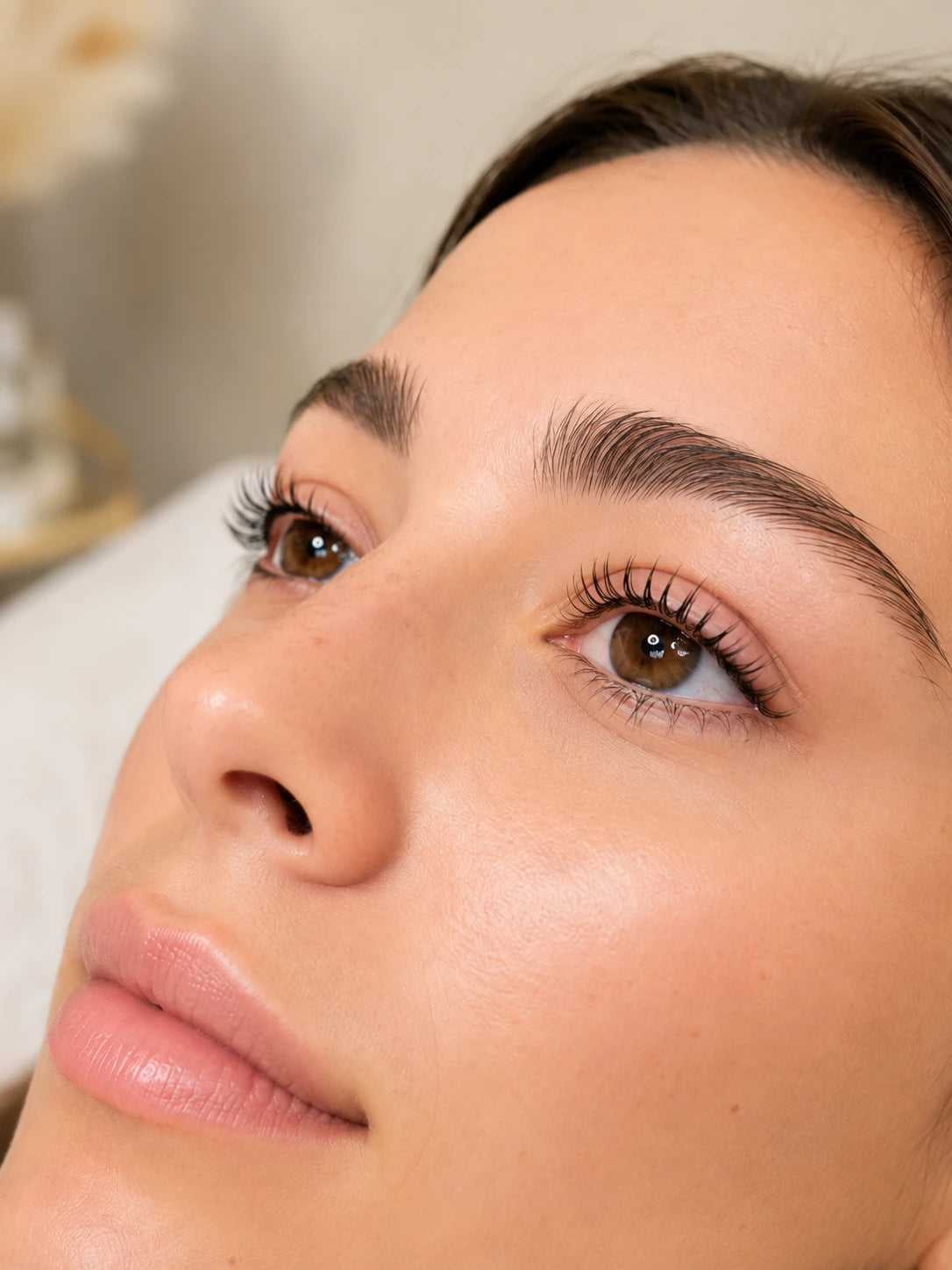 Close-up of natural lifted lashes and groomed eyebrows on a female client near Ryde