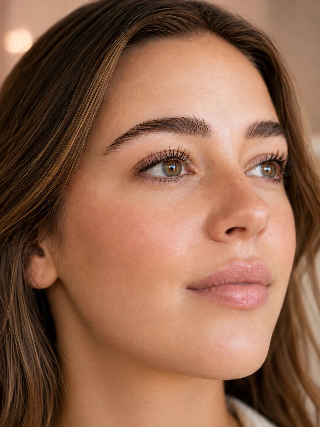 Close-up of natural lifted lashes and groomed eyebrows on a female client near Putney