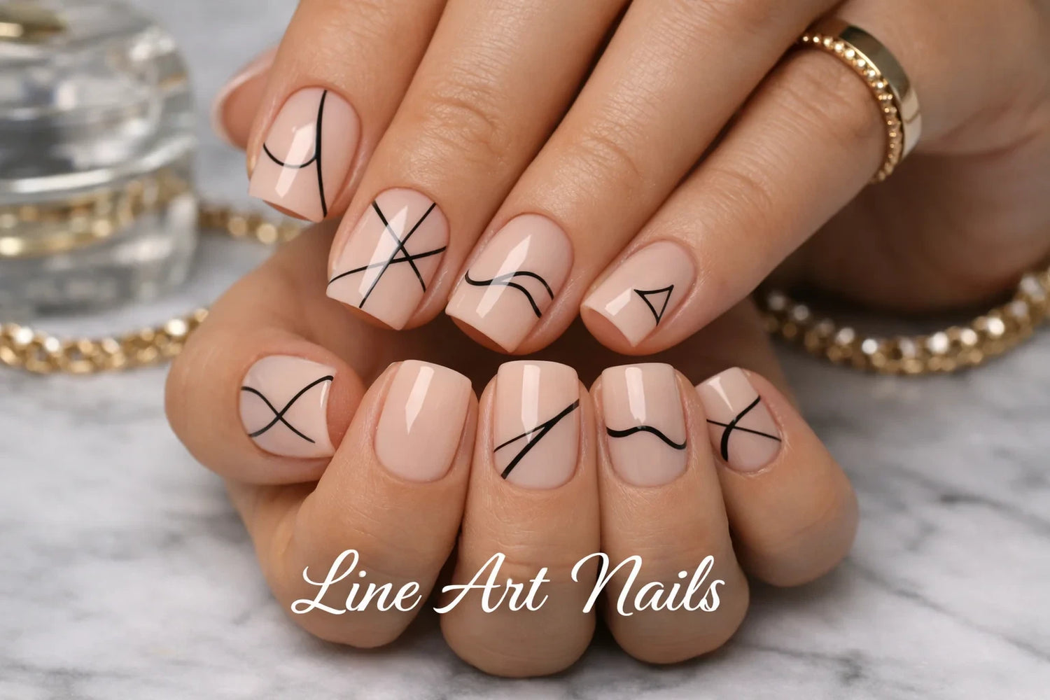 Close-up of nude square nails with black minimalist line art designs
