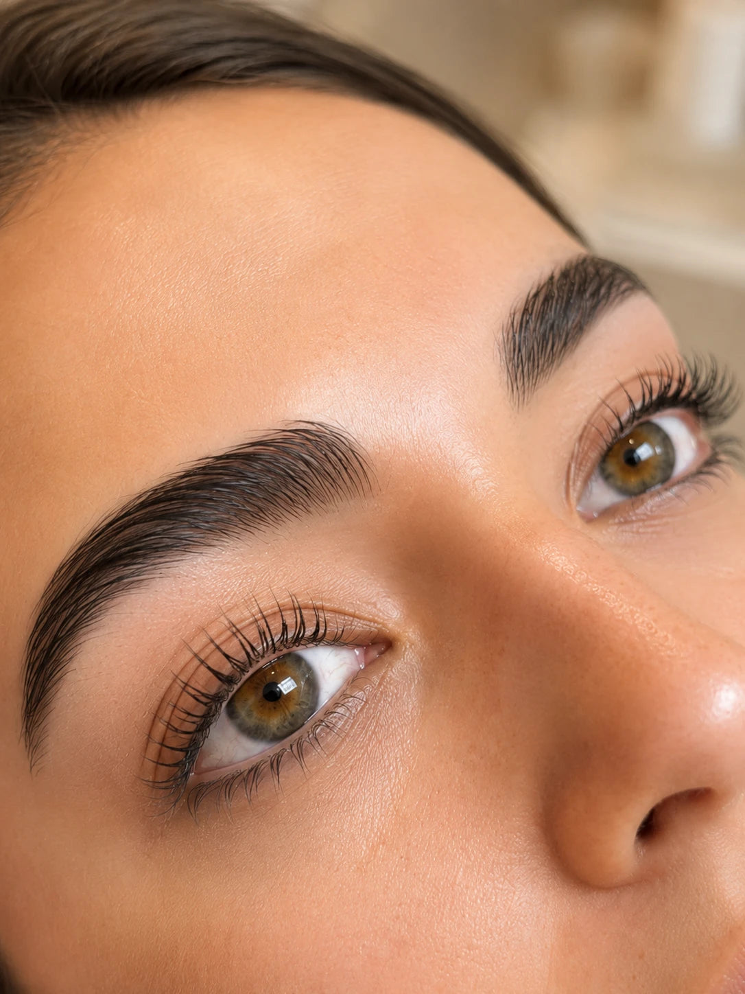 Close-up of natural lifted lashes and groomed eyebrows on a female client near Rhodes
